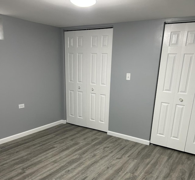 16873 Bulger Ave, Hazel Crest, IL 60429 - unfurnished bedroom with dark wood-style flooring, baseboards, and a closet