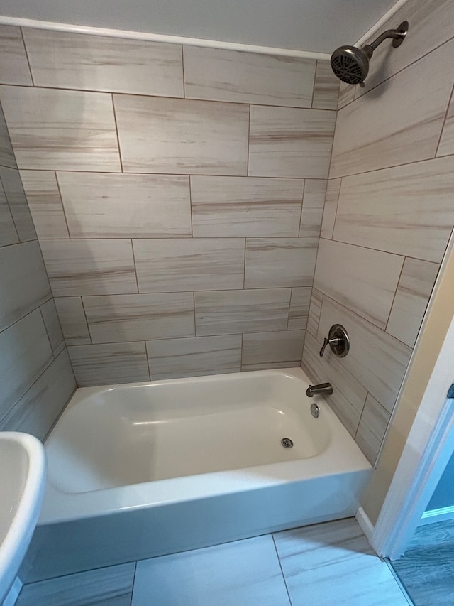 bathroom with tiled shower / bath combo and tile patterned floors