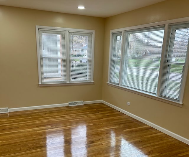 spare room with hardwood / wood-style flooring