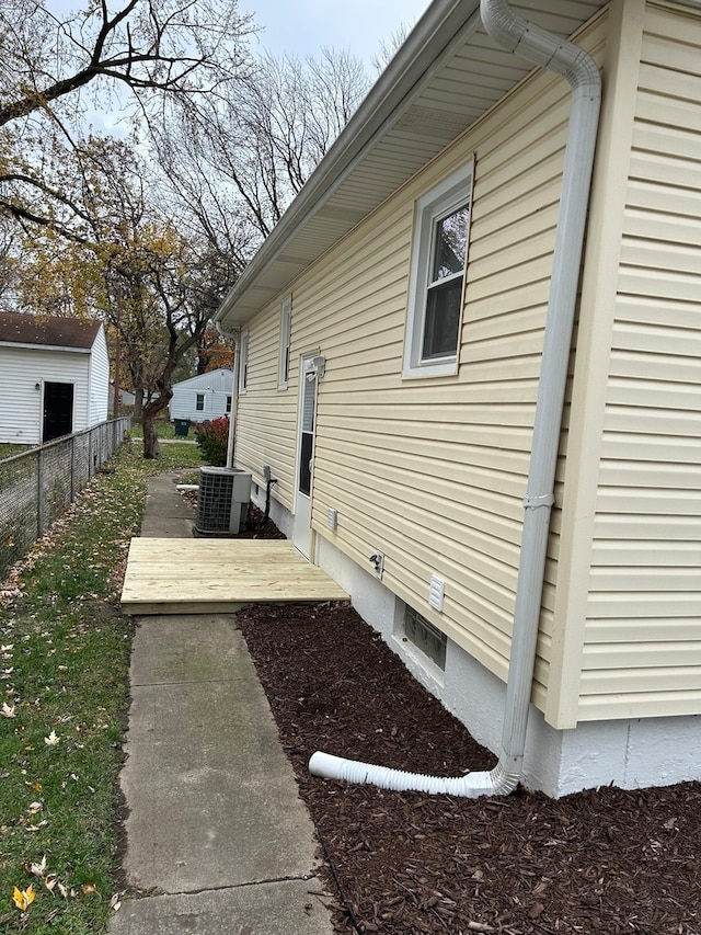 view of side of home featuring central AC unit