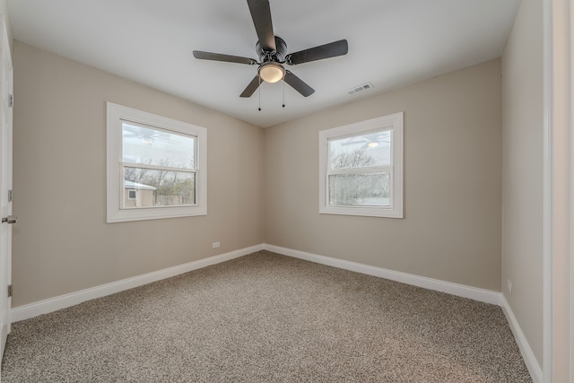 spare room with ceiling fan and carpet