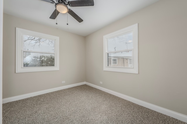 carpeted empty room with ceiling fan and a healthy amount of sunlight