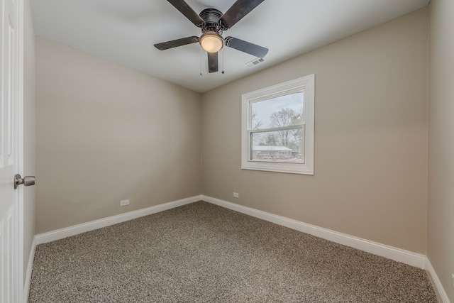 carpeted spare room featuring ceiling fan