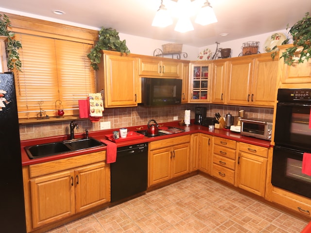 kitchen featuring sink, tasteful backsplash, and black appliances