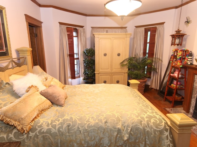 bedroom with crown molding and dark wood-type flooring