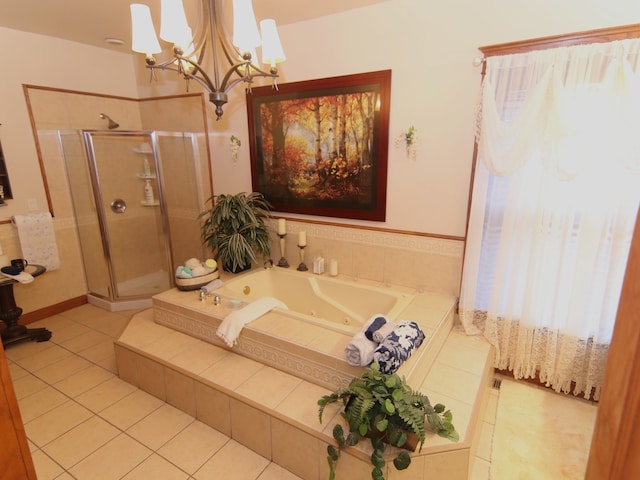 bathroom featuring tile patterned floors, a notable chandelier, and shower with separate bathtub