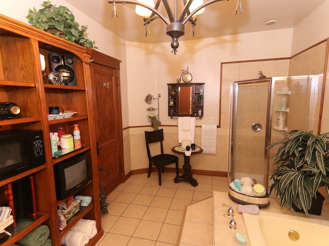 interior space with light tile patterned floors, tile walls, and an inviting chandelier