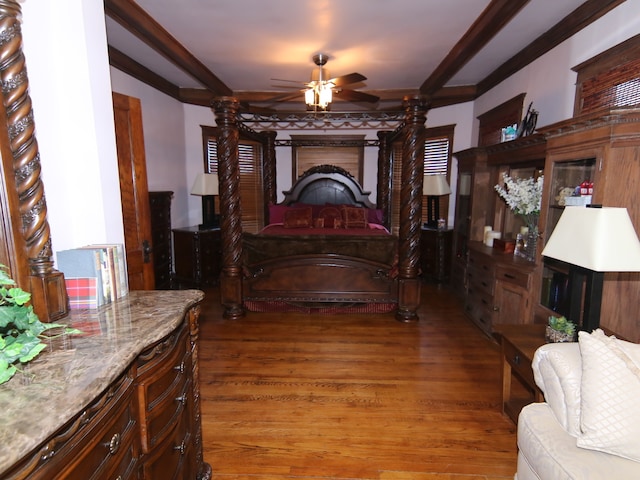 bedroom with ornamental molding and dark wood-type flooring