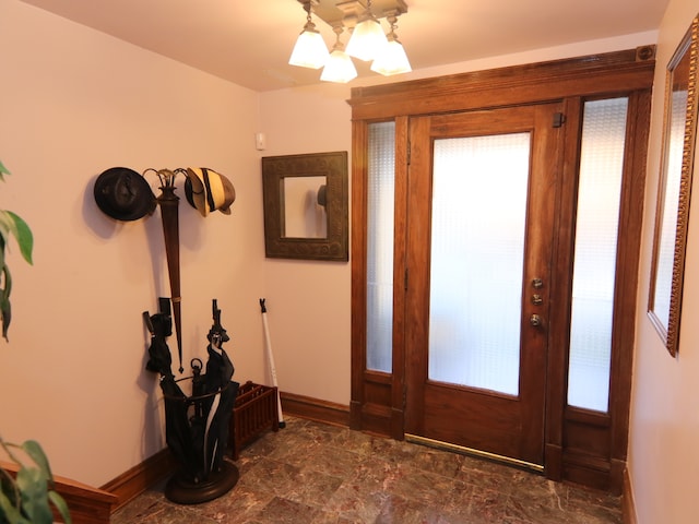 foyer entrance featuring an inviting chandelier