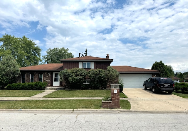 tri-level home with a garage and a front yard