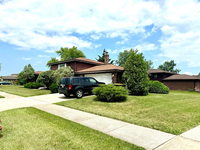 view of front of property featuring a garage and a front lawn