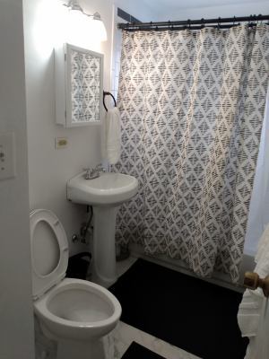 full bathroom with shower / bath combination with curtain, toilet, and sink