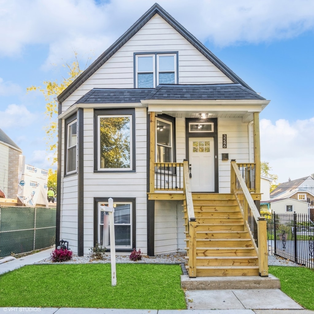 view of front facade with covered porch and a front yard