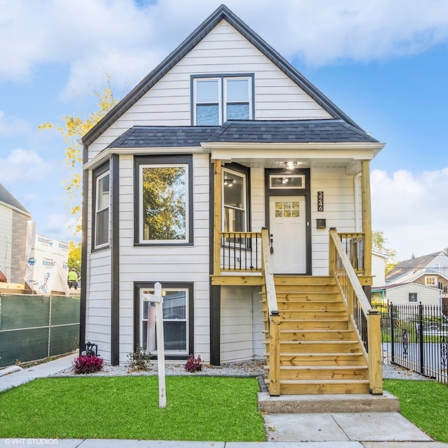 view of front facade with covered porch and a front yard