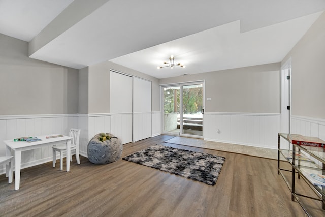 living area with a notable chandelier and hardwood / wood-style flooring