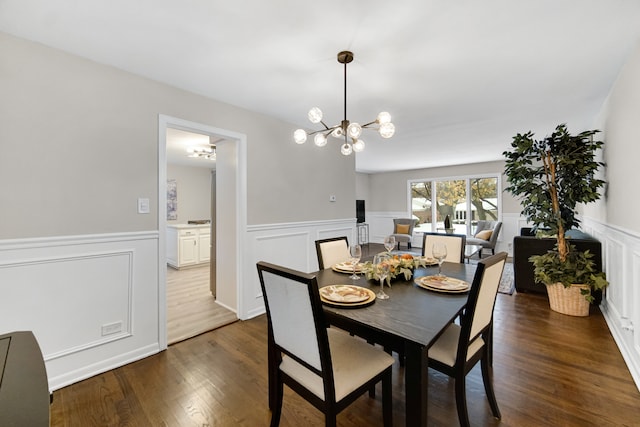 dining area featuring an inviting chandelier and dark wood-type flooring