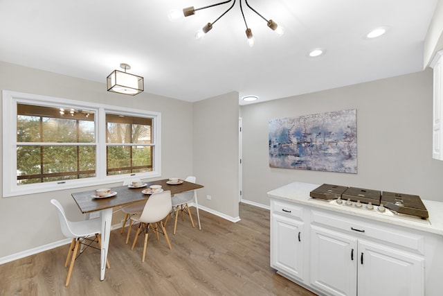 dining space featuring a notable chandelier and light hardwood / wood-style flooring