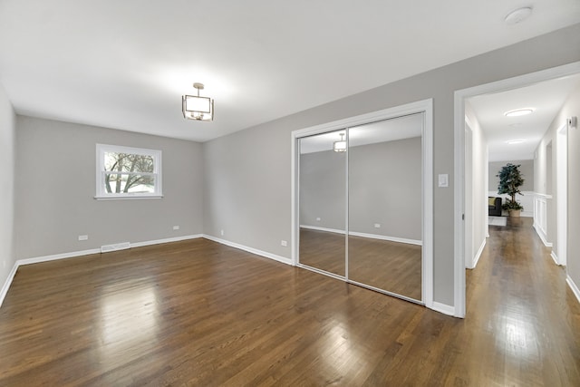 unfurnished bedroom featuring dark hardwood / wood-style floors