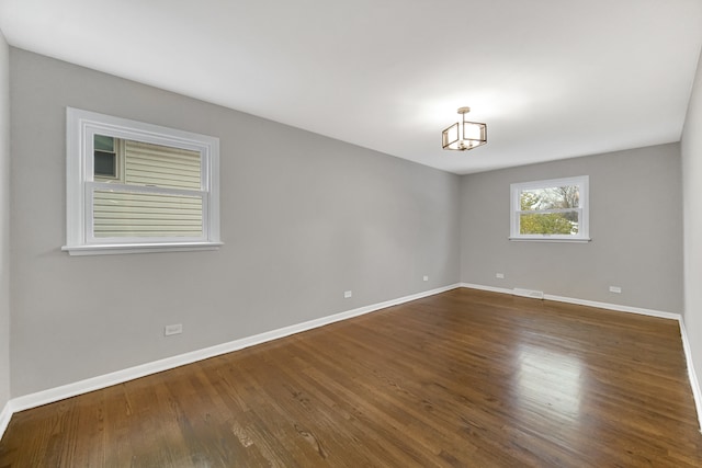 spare room featuring dark hardwood / wood-style floors