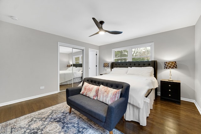 bedroom with dark hardwood / wood-style flooring, a closet, and ceiling fan