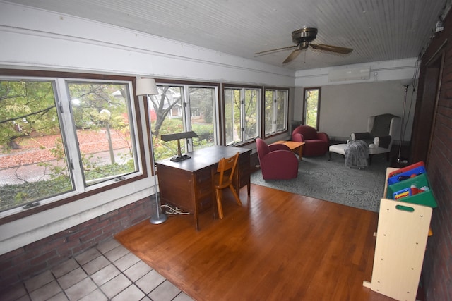 sunroom / solarium with an AC wall unit, a wealth of natural light, and ceiling fan