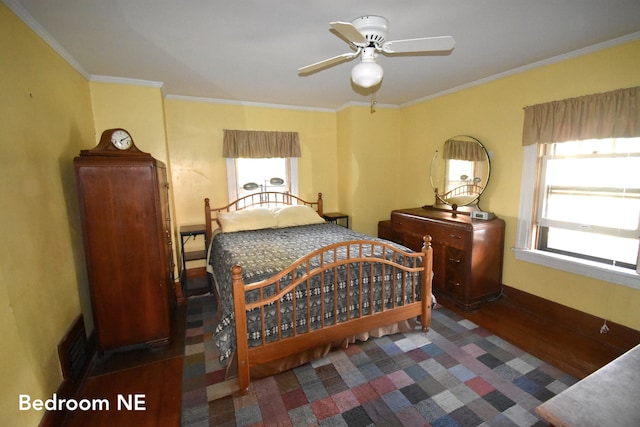 bedroom featuring dark hardwood / wood-style flooring, ceiling fan, and crown molding