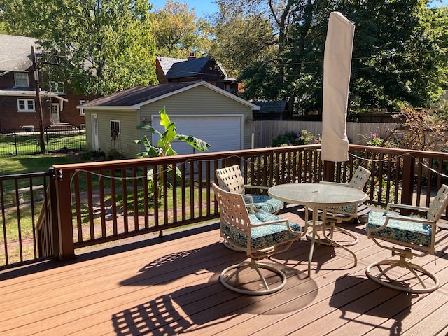 deck featuring a garage and an outdoor structure