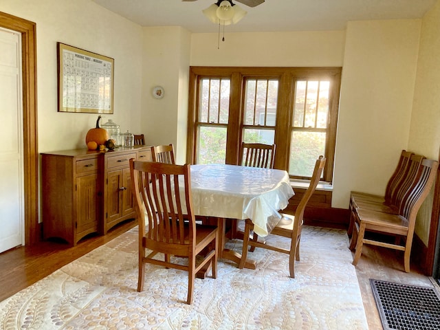 dining area with light hardwood / wood-style flooring and ceiling fan