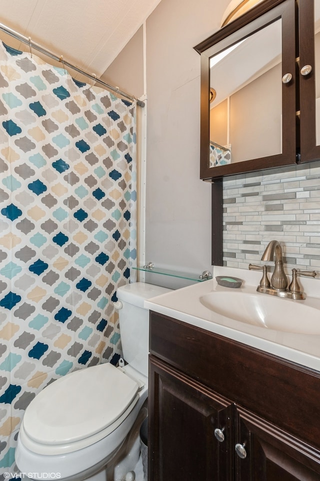 bathroom with backsplash, vanity, a shower with shower curtain, and toilet