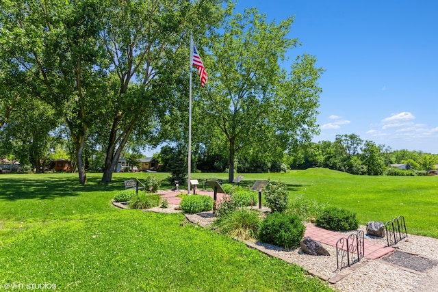 view of property's community with a lawn