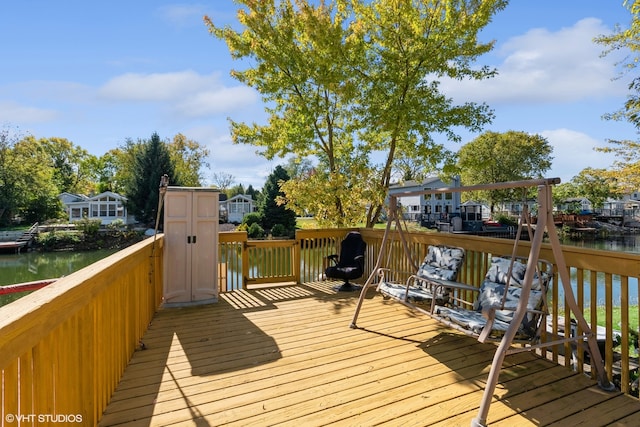 wooden deck featuring a water view