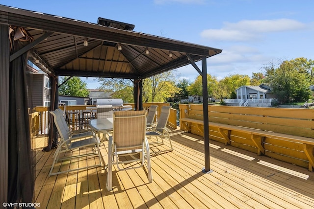 185 Eon Ln, Wilmington, IL 60481 - wooden deck featuring outdoor dining area, a gazebo, and a grill
