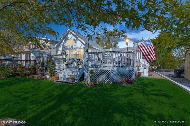 back of property with a wooden deck and a yard