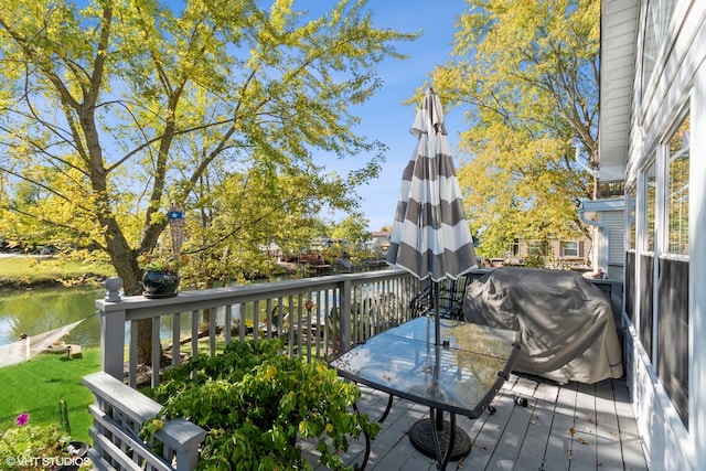 deck with a water view and grilling area