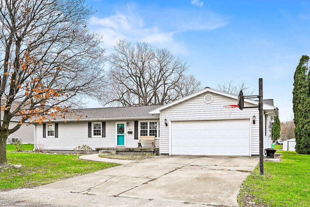 ranch-style home with a front yard and a garage