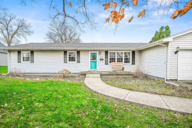 single story home featuring a garage and a front lawn