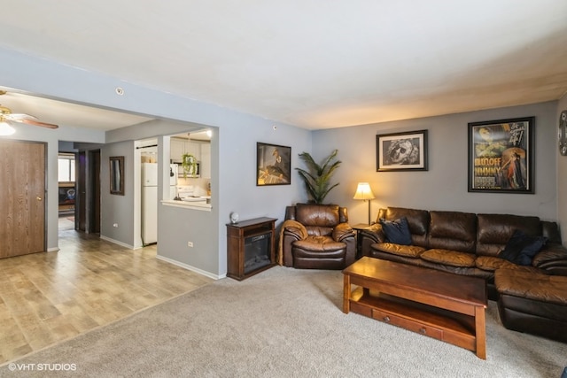 living room featuring light carpet and ceiling fan