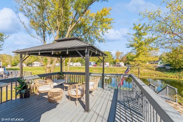 wooden deck with a gazebo and a water view