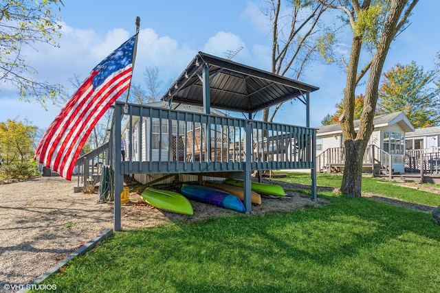 view of play area featuring a deck and a lawn