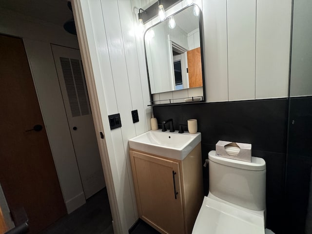 bathroom with vanity, toilet, and backsplash