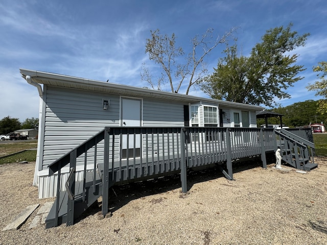 back of property with a wooden deck