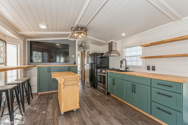 kitchen with wall chimney exhaust hood, wood counters, and dark wood-type flooring