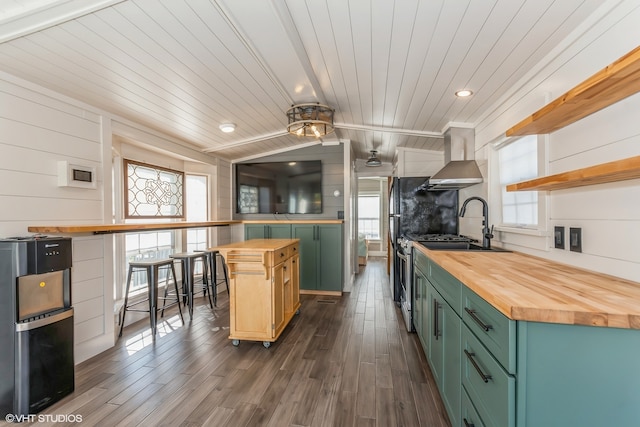 kitchen featuring wooden counters, dark hardwood / wood-style flooring, wood ceiling, wall chimney range hood, and a center island