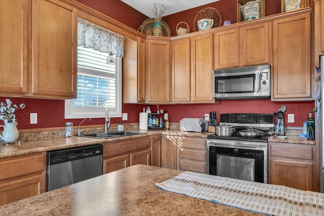 kitchen featuring light countertops, appliances with stainless steel finishes, and a sink