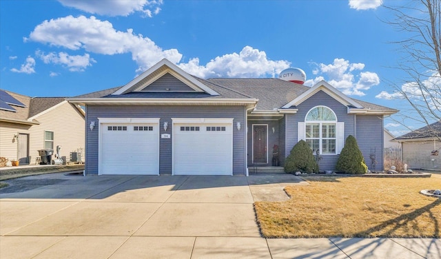 single story home featuring a front lawn, central air condition unit, an attached garage, and driveway