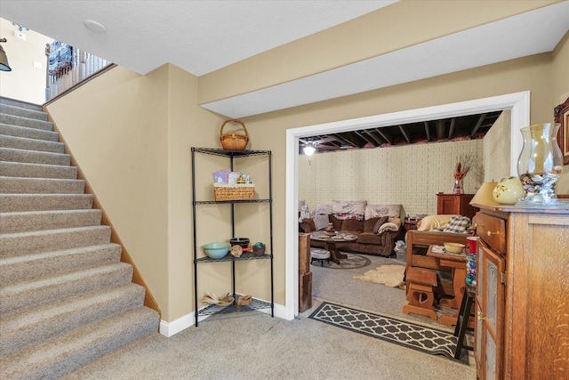 basement with carpet flooring, stairway, and baseboards