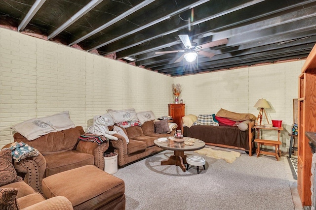 living area featuring a ceiling fan, brick wall, and carpet floors