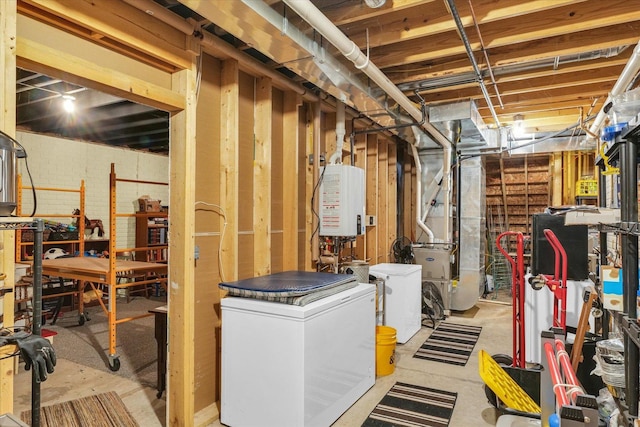 unfinished below grade area featuring tankless water heater, heating unit, refrigerator, and brick wall