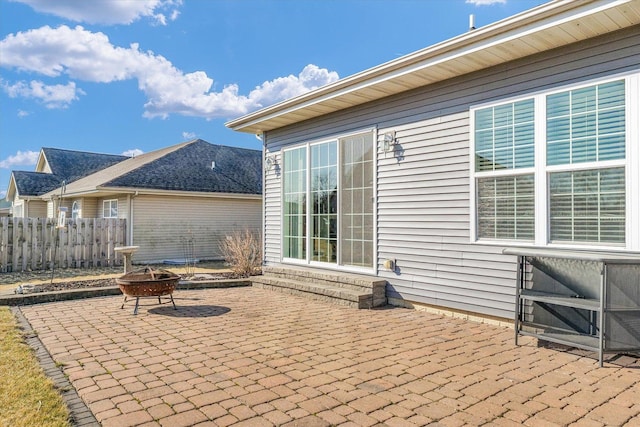 view of patio / terrace with a fire pit and fence