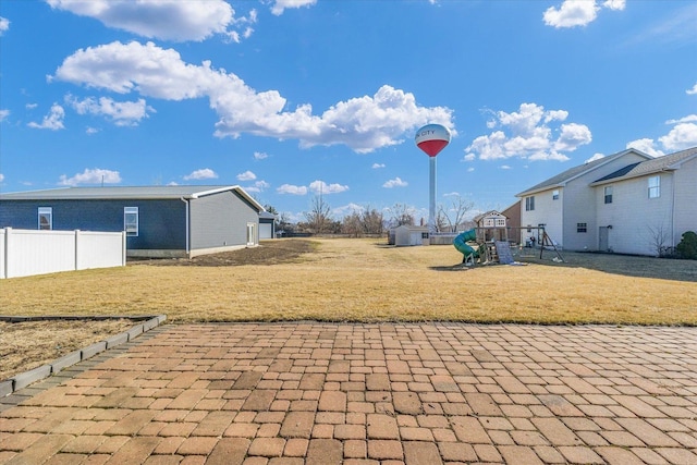 view of yard featuring a playground and fence